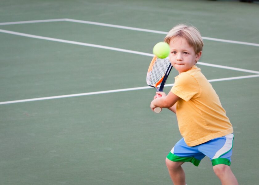 Young boy playing Tennis.