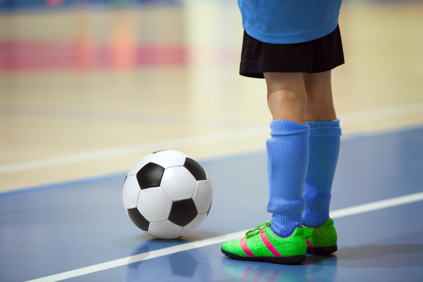 Soccer player getting ready to kick the ball inbounds.