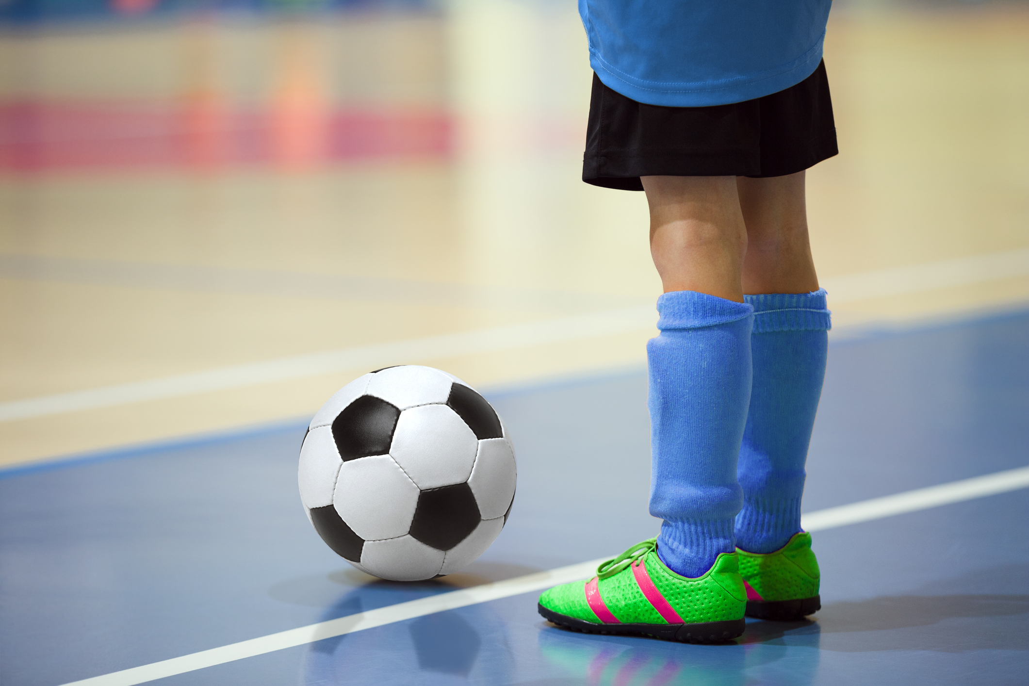 Soccer player getting ready to kick the ball inbounds.